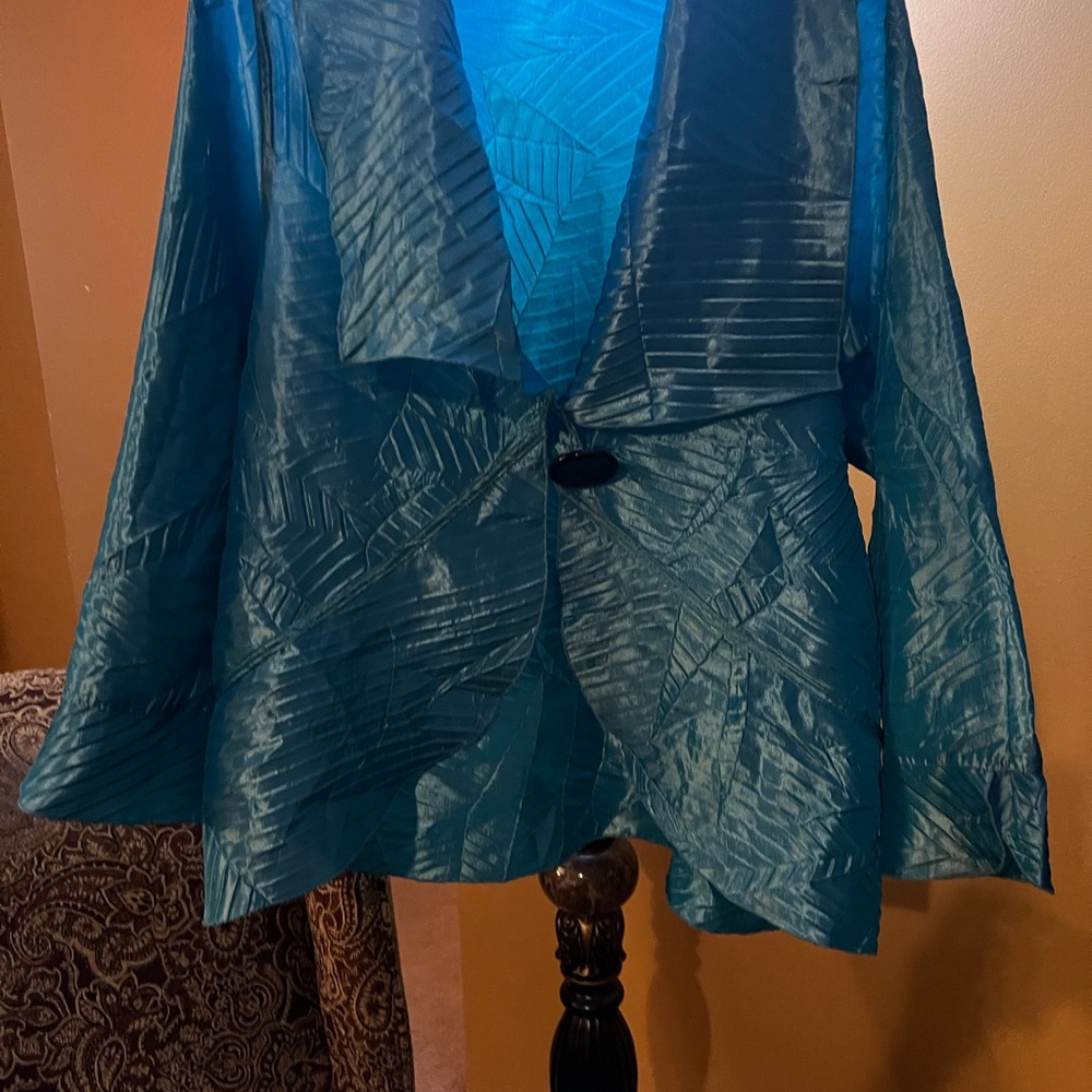 Woman’s Jacket Connie’s Moonlight. Color is turquoise with a black button. Sz. M
